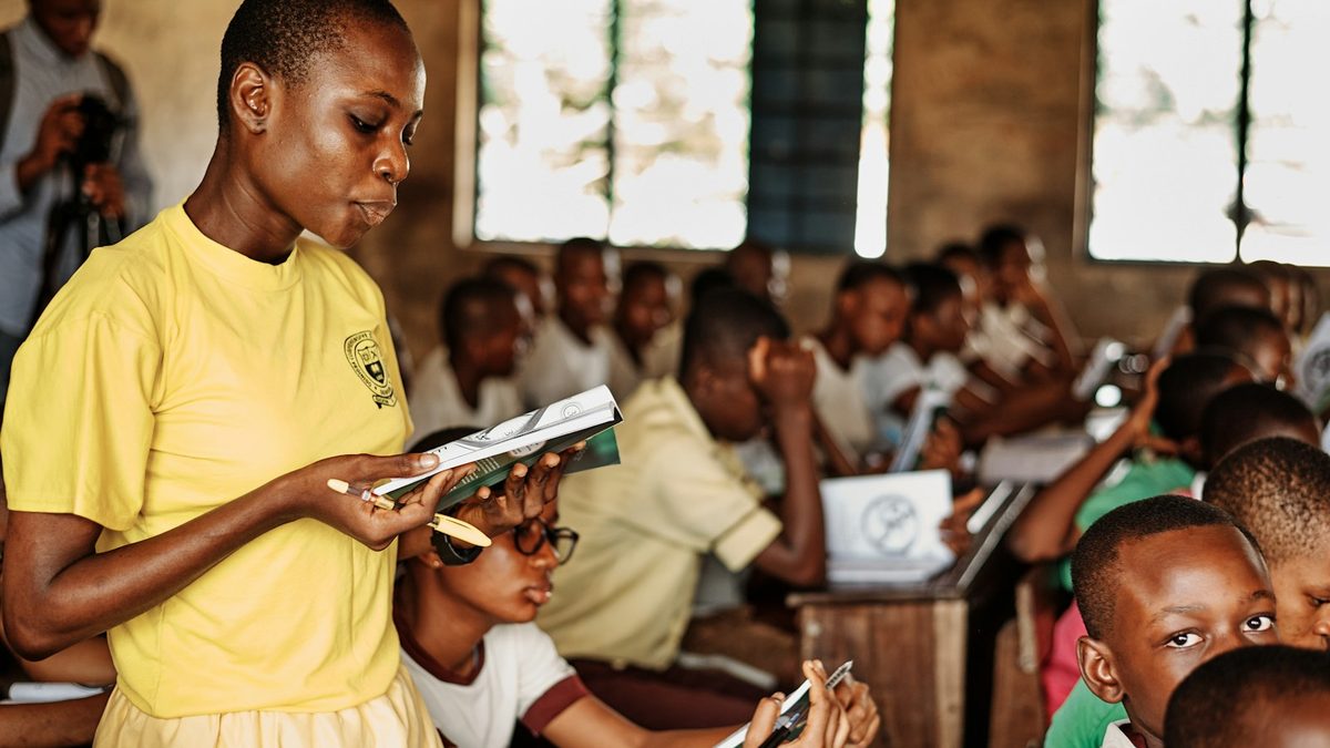 Teacher working with a class of children in an African school